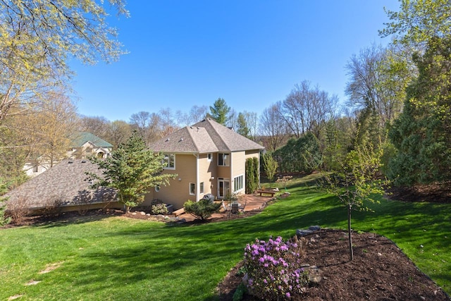 rear view of house with a yard
