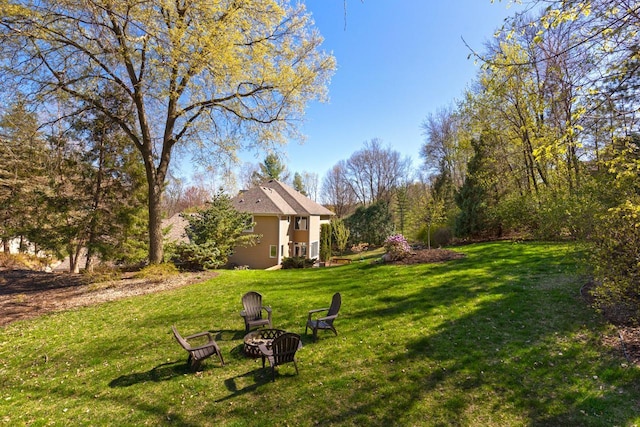 view of yard featuring an outdoor fire pit