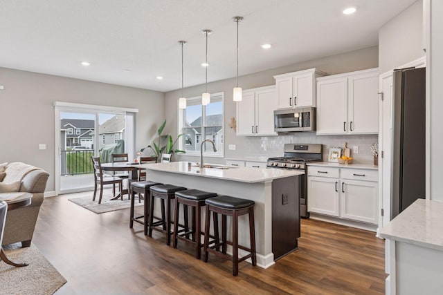 7393 Emily Cir, Lino Lakes, MN 55038 - kitchen with white cabinets, backsplash, appliances with stainless steel finishes, and a sink