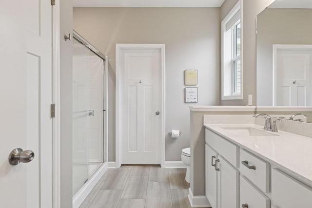 7393 Emily Cir, Lino Lakes, MN 55038 - bathroom with vanity, toilet, baseboards, and a stall shower