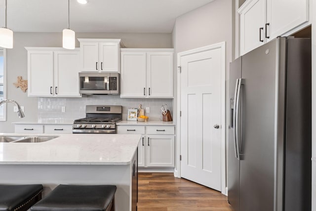 7393 Emily Cir, Lino Lakes, MN 55038 - kitchen with white cabinets, backsplash, appliances with stainless steel finishes, and a sink