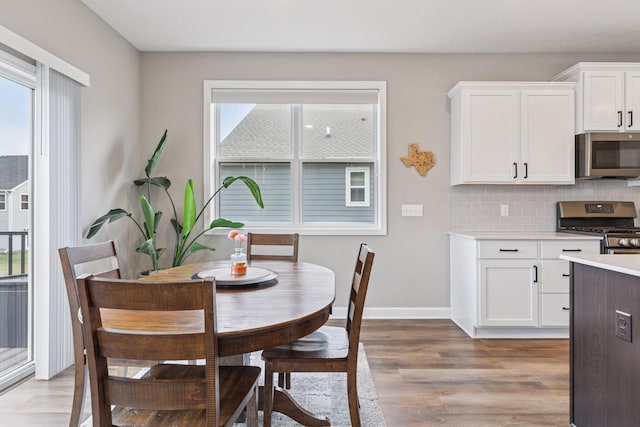 7393 Emily Cir, Lino Lakes, MN 55038 - dining room featuring baseboards and light wood-type flooring