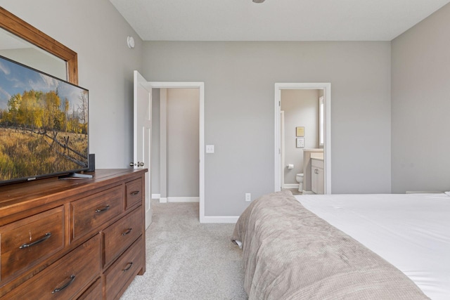 7393 Emily Cir, Lino Lakes, MN 55038 - bedroom featuring light colored carpet, ensuite bathroom, and baseboards