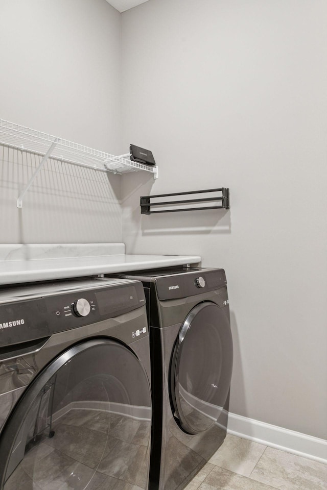 7393 Emily Cir, Lino Lakes, MN 55038 - laundry area with washing machine and clothes dryer, baseboards, and laundry area