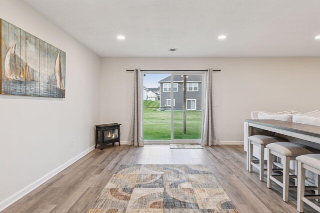 7393 Emily Cir, Lino Lakes, MN 55038 - dining room featuring a wood stove, recessed lighting, baseboards, and wood finished floors