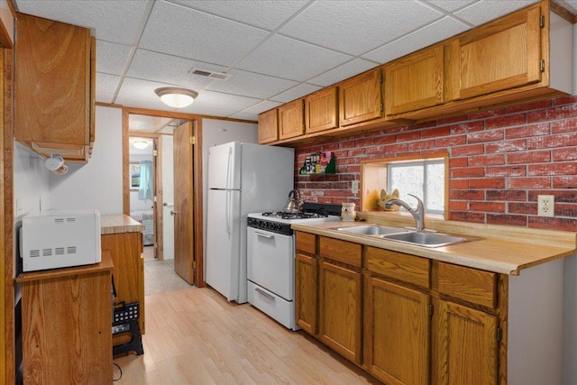 822 138th St Unit 32, Garfield Twp, WI 54001 - kitchen with a sink, white appliances, light countertops, a paneled ceiling, and visible vents