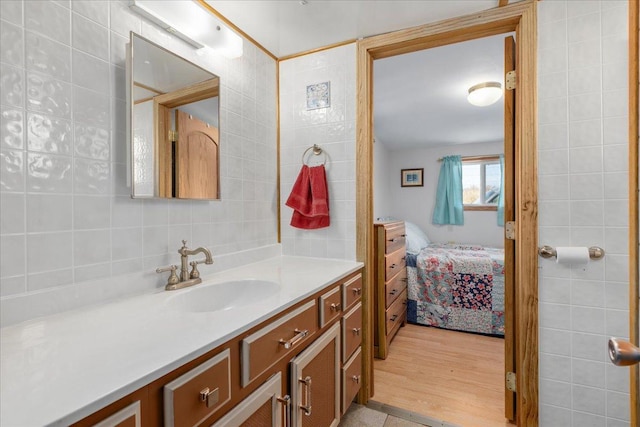822 138th St Unit 32, Garfield Twp, WI 54001 - ensuite bathroom with vanity, ensuite bathroom, decorative backsplash, and wood finished floors