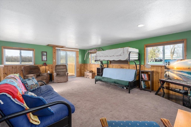 822 138th St Unit 32, Garfield Twp, WI 54001 - bedroom with a textured ceiling, wood walls, wainscoting, and multiple windows