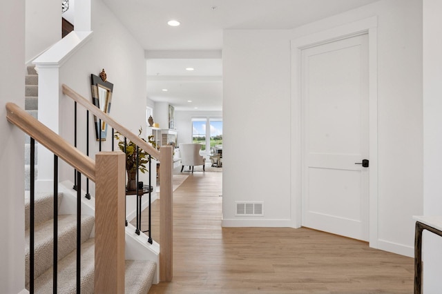 entrance foyer with recessed lighting, stairway, visible vents, and light wood finished floors