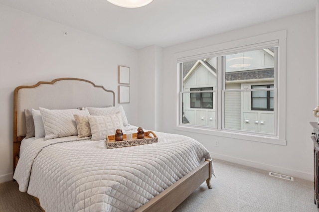 bedroom with visible vents, baseboards, and carpet floors