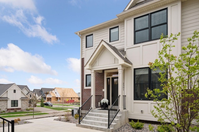 view of front of property featuring brick siding and a residential view