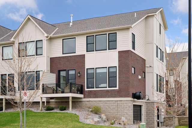 2301 Simply Living Ln, Hudson, WI 54016 - back of property featuring brick siding, a yard, and a shingled roof