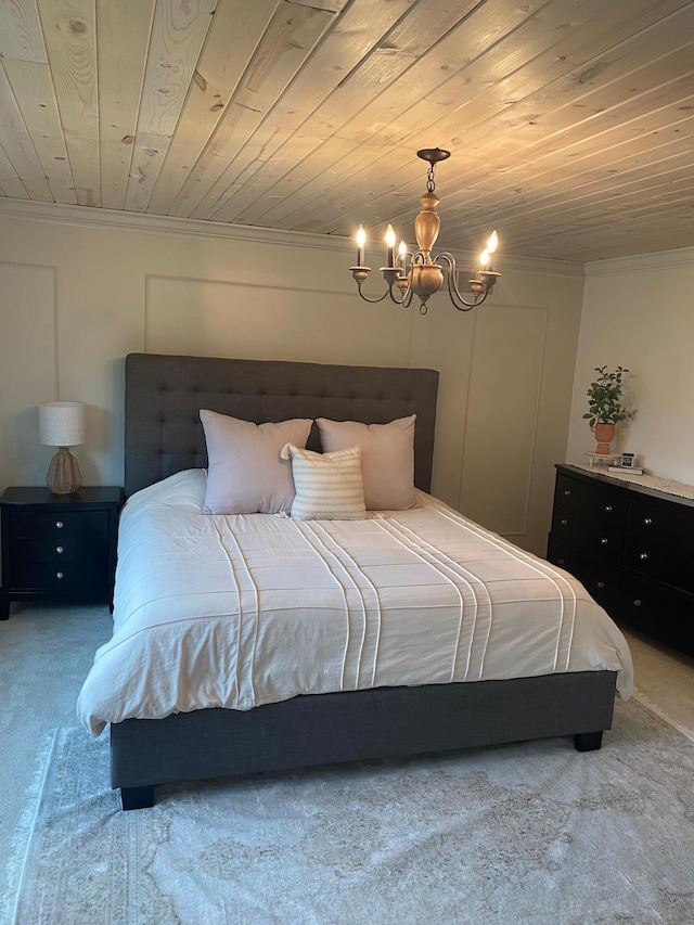 bedroom with wood ceiling, ornamental molding, carpet flooring, and a notable chandelier