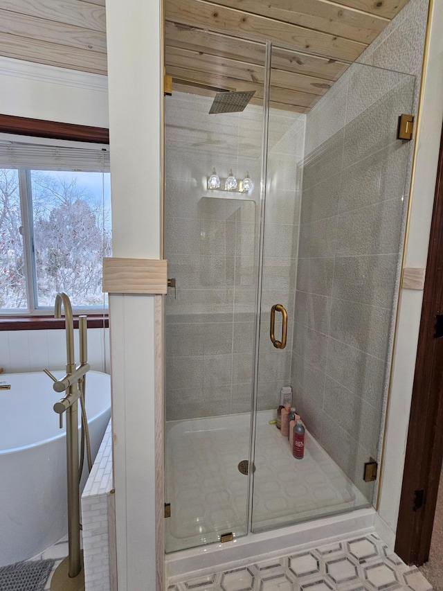 bathroom with a freestanding tub and a stall shower
