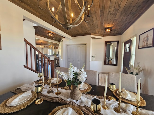 dining area with wood ceiling, plenty of natural light, a notable chandelier, ornamental molding, and stairs