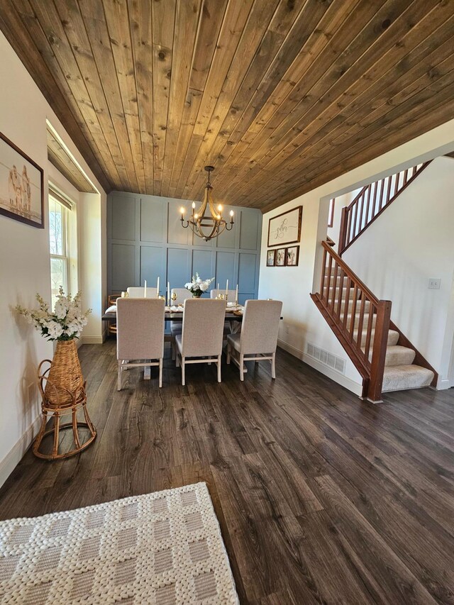 dining room featuring a notable chandelier, visible vents, dark wood-style floors, and stairway