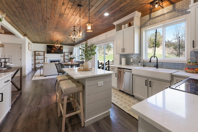 kitchen with wood ceiling, a kitchen island, dishwasher, a sink, and dark wood-type flooring