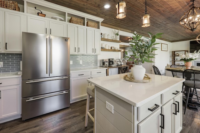 kitchen featuring freestanding refrigerator, open shelves, wooden ceiling, and light countertops