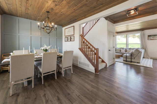 dining space with a notable chandelier, visible vents, wooden ceiling, and a decorative wall
