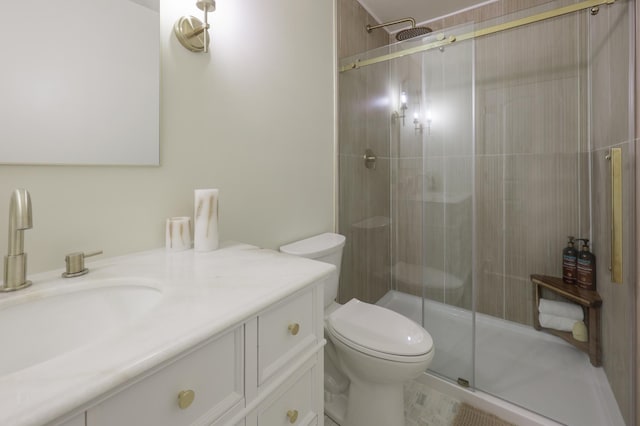 bathroom with vanity, toilet, and a stall shower