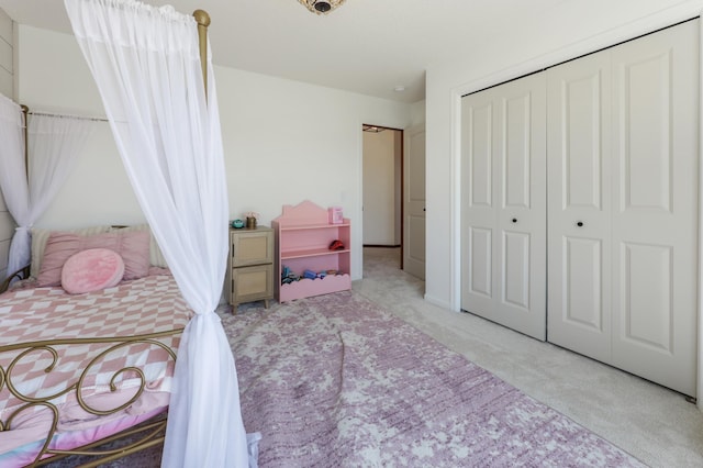 bedroom with light carpet and a closet