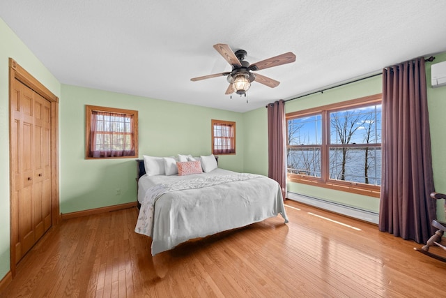 63626 Hannu Ln, Finlayson, MN 55735 - bedroom with baseboard heating, hardwood / wood-style floors, baseboards, and a water view
