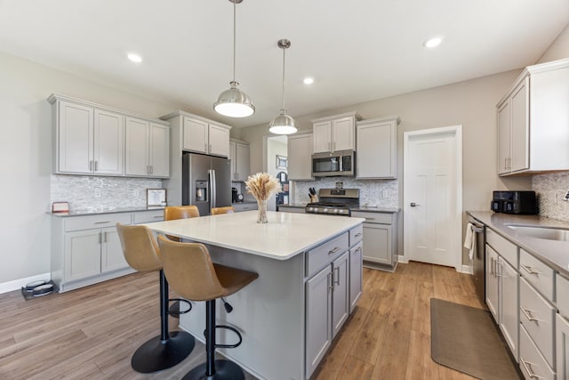 2133 Johanna Cir, Lino Lakes, MN 55038 - kitchen with appliances with stainless steel finishes, backsplash, a center island, and recessed lighting