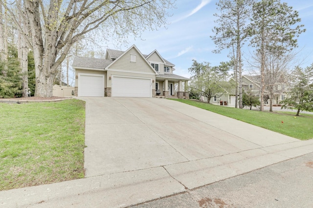 562 Hillside Dr, Prescott, WI 54021 - view of front of property with an attached garage, a front yard, concrete driveway, and covered porch