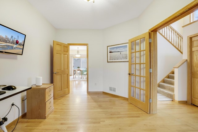 562 Hillside Dr, Prescott, WI 54021 - corridor featuring light wood finished floors, stairway, plenty of natural light, and french doors