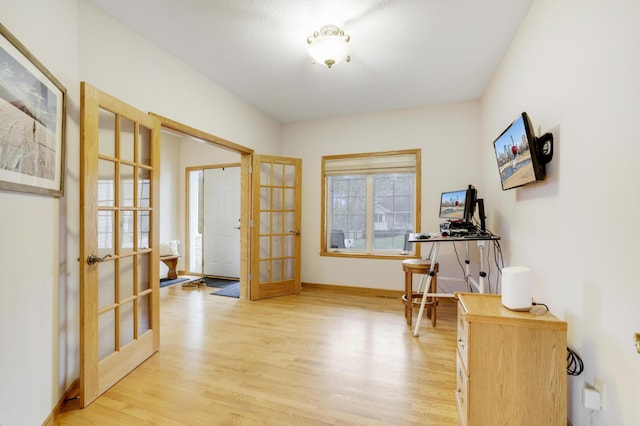 562 Hillside Dr, Prescott, WI 54021 - doorway with french doors, light wood-type flooring, and baseboards