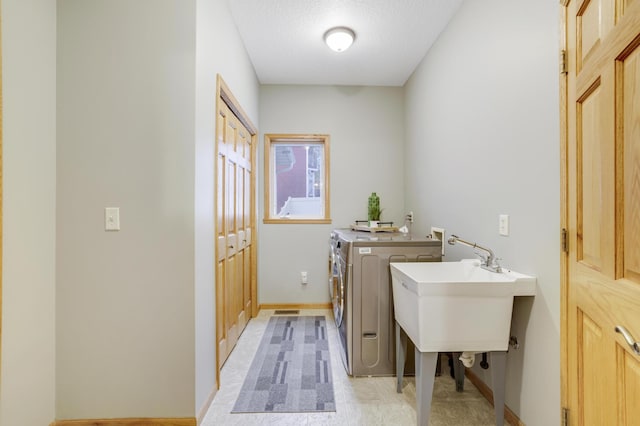 562 Hillside Dr, Prescott, WI 54021 - laundry area with washing machine and dryer and baseboards