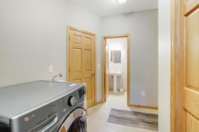 562 Hillside Dr, Prescott, WI 54021 - laundry room featuring washer / dryer, baseboards, and a sink