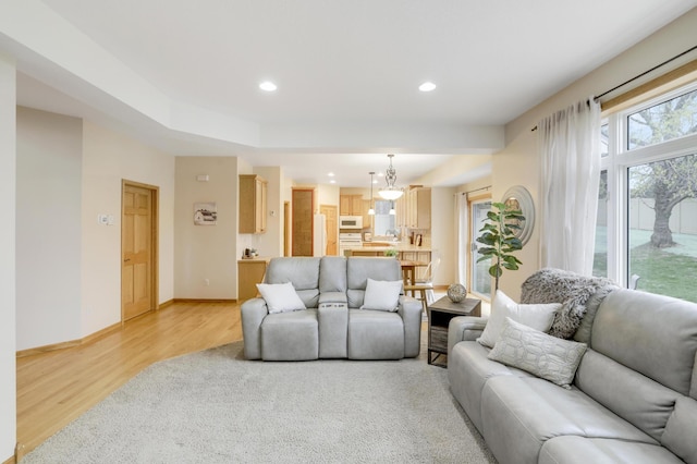 562 Hillside Dr, Prescott, WI 54021 - living area featuring light wood-style floors, recessed lighting, baseboards, and a chandelier