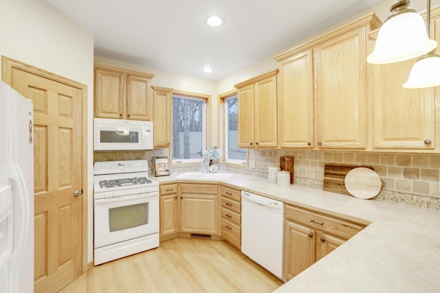 562 Hillside Dr, Prescott, WI 54021 - kitchen with white appliances, light brown cabinetry, light countertops, tasteful backsplash, and a sink