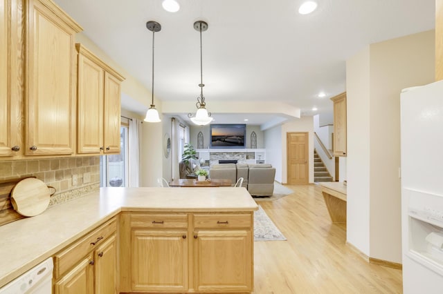 562 Hillside Dr, Prescott, WI 54021 - kitchen featuring light brown cabinets, a peninsula, a fireplace, dishwasher, and backsplash