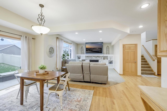 562 Hillside Dr, Prescott, WI 54021 - dining space featuring light wood finished floors, stairway, a fireplace, and recessed lighting