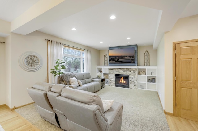 562 Hillside Dr, Prescott, WI 54021 - living room featuring a glass covered fireplace, baseboards, recessed lighting, and light wood-style flooring