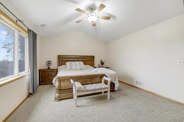 562 Hillside Dr, Prescott, WI 54021 - carpeted bedroom featuring multiple windows, baseboards, vaulted ceiling, and a ceiling fan