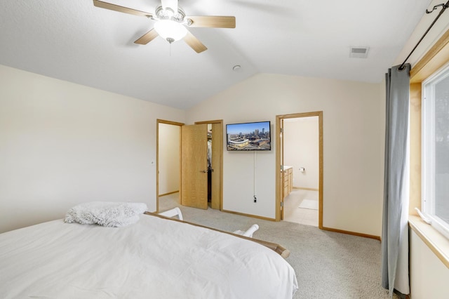 562 Hillside Dr, Prescott, WI 54021 - bedroom with lofted ceiling, light carpet, baseboards, connected bathroom, and a ceiling fan