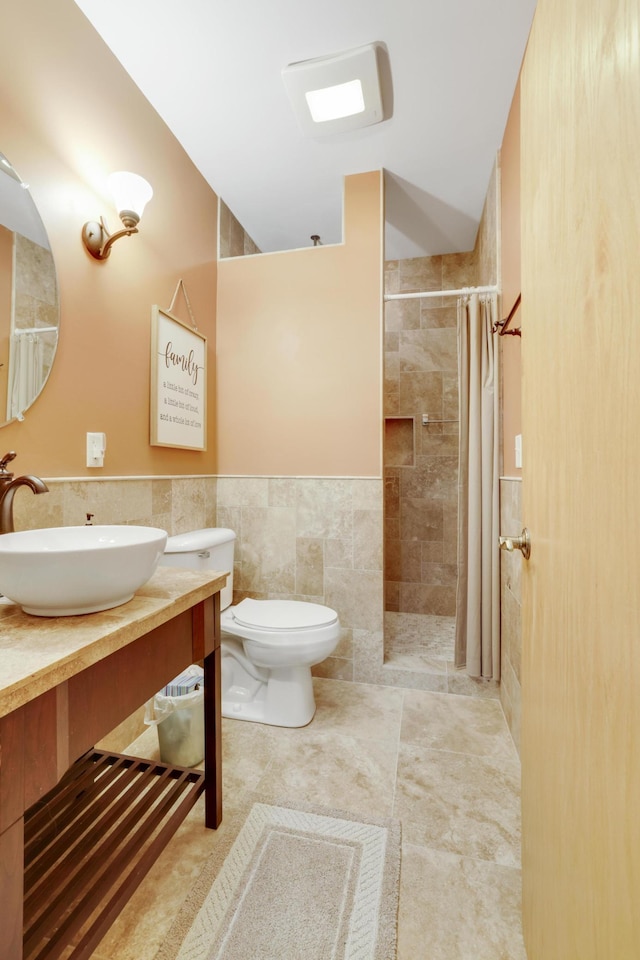 562 Hillside Dr, Prescott, WI 54021 - full bath featuring tile walls, a tile shower, tile patterned flooring, vanity, and toilet