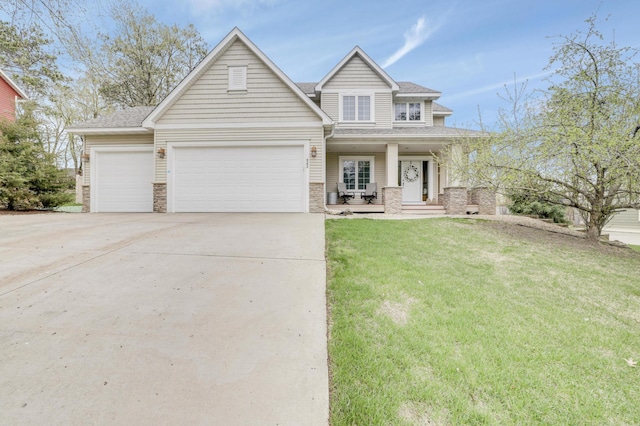 562 Hillside Dr, Prescott, WI 54021 - view of front of property featuring concrete driveway, an attached garage, a front yard, roof with shingles, and covered porch