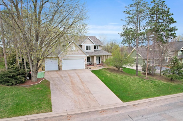 562 Hillside Dr, Prescott, WI 54021 - craftsman inspired home featuring an attached garage, driveway, a front lawn, and covered porch