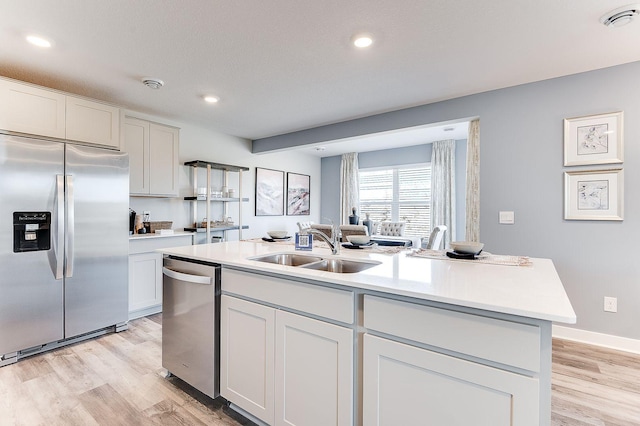 19454 136th Ave N, Rogers, MN 55374 - kitchen featuring stainless steel appliances, light countertops, light wood-style flooring, and a sink