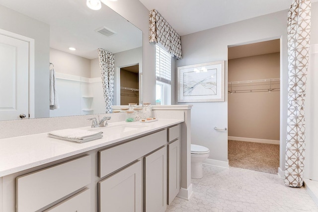 19454 136th Ave N, Rogers, MN 55374 - bathroom featuring a spacious closet, toilet, vanity, visible vents, and a shower