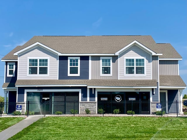 19454 136th Ave N, Rogers, MN 55374 - view of front of house with fence, a shingled roof, and a front yard