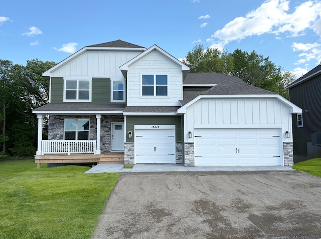 14234 Empire Ln N, Dayton, MN 55327 - view of front of home featuring board and batten siding, driveway, a shingled roof, and stone siding
