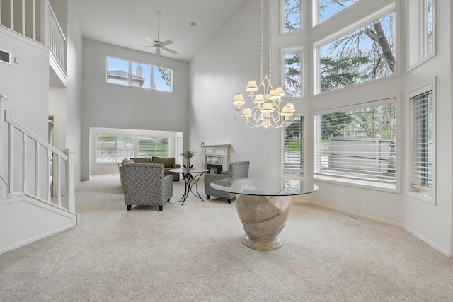 5541 70th St, Edina, MN 55439 - dining area with a high ceiling, carpet, a fireplace, stairway, and ceiling fan
