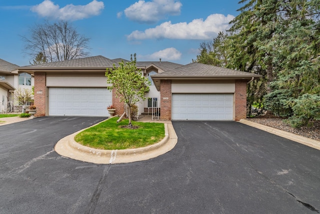 5541 70th St, Edina, MN 55439 - view of front of house with brick siding, a garage, and asphalt driveway
