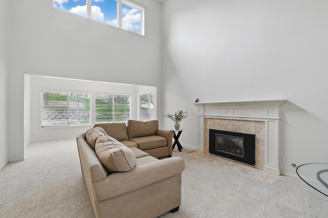 5541 70th St, Edina, MN 55439 - carpeted living room featuring a towering ceiling, plenty of natural light, a fireplace, and baseboards