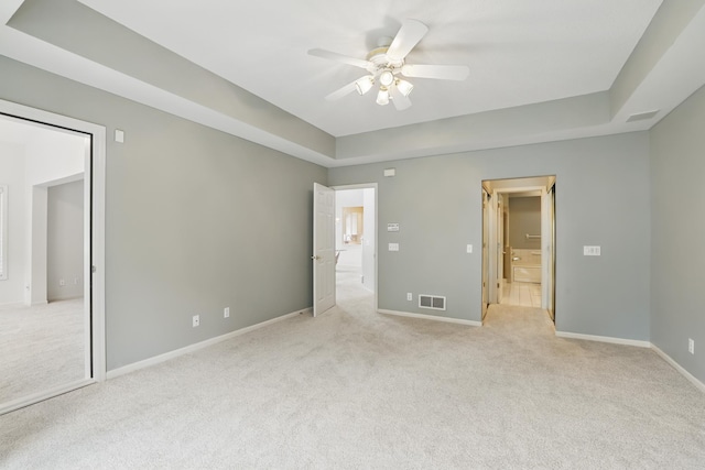 5541 70th St, Edina, MN 55439 - unfurnished bedroom with light colored carpet, a tray ceiling, and baseboards